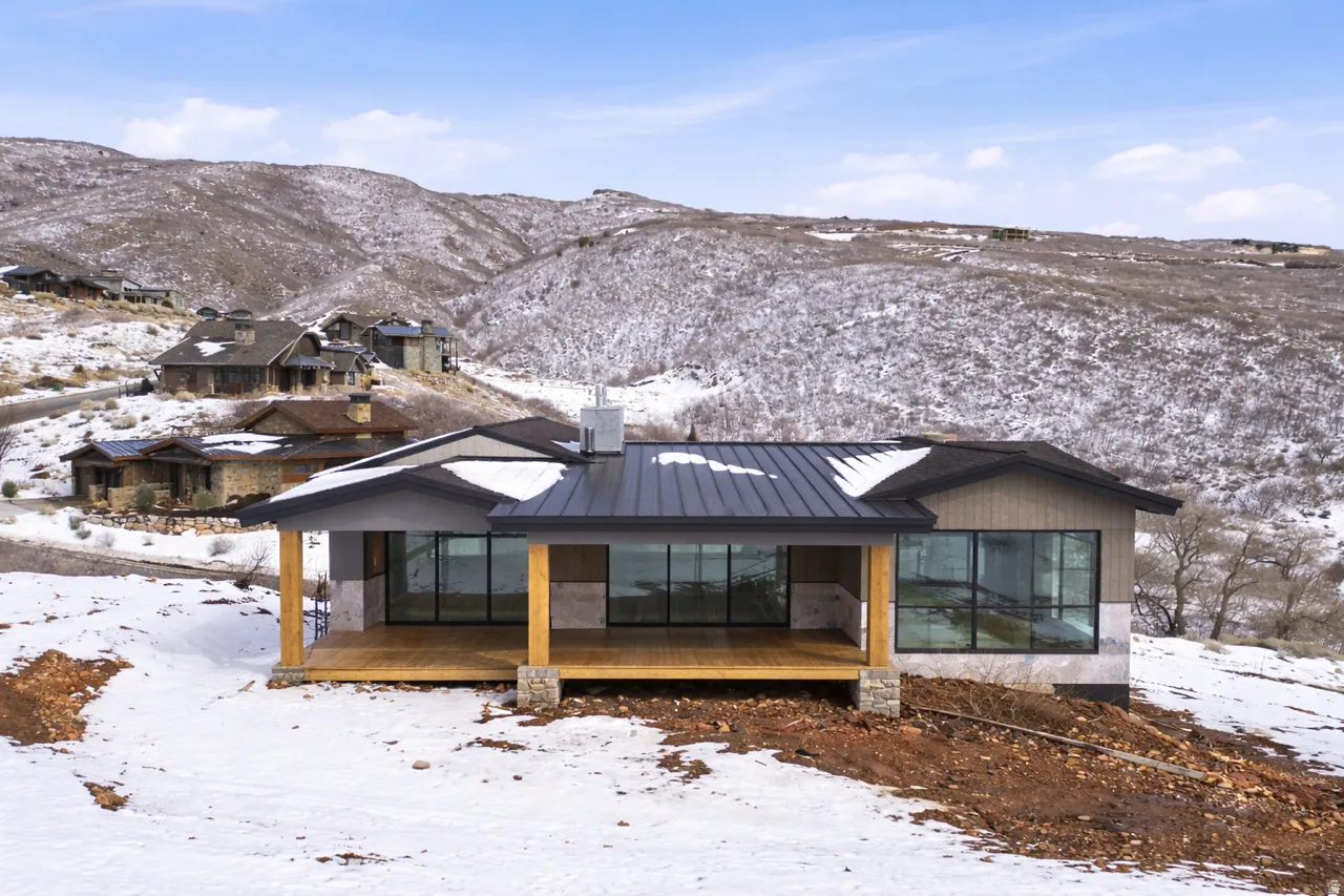 View of front facade with a standing seam roof and a deck with mountain view