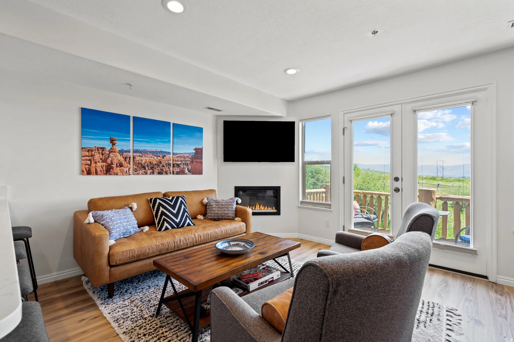 Living area with light wood-style flooring, a gas fireplace, and recessed lighting