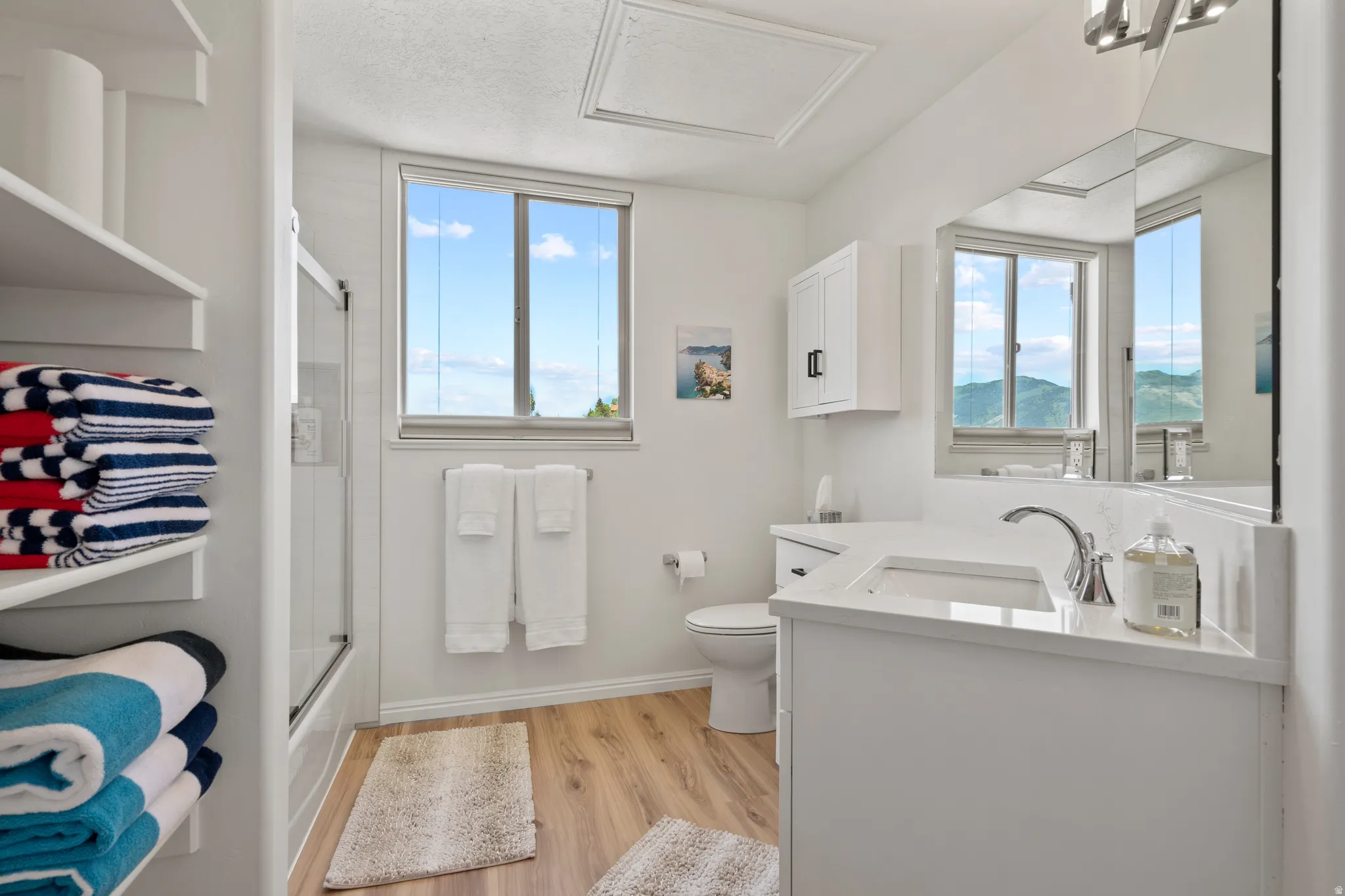 Primary bathroom featuring vanity, and enclosed tub / shower combo