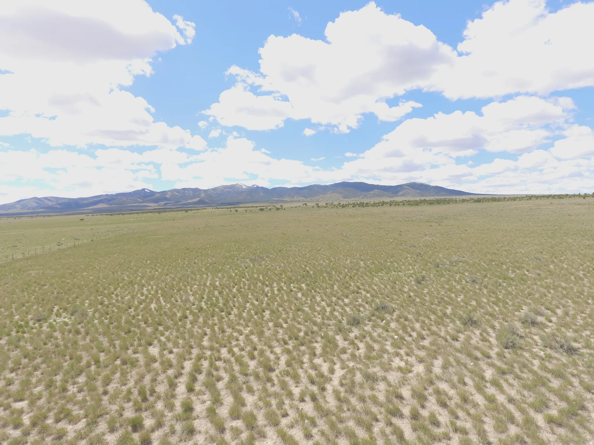 View of mountain backdrop with rural landscape