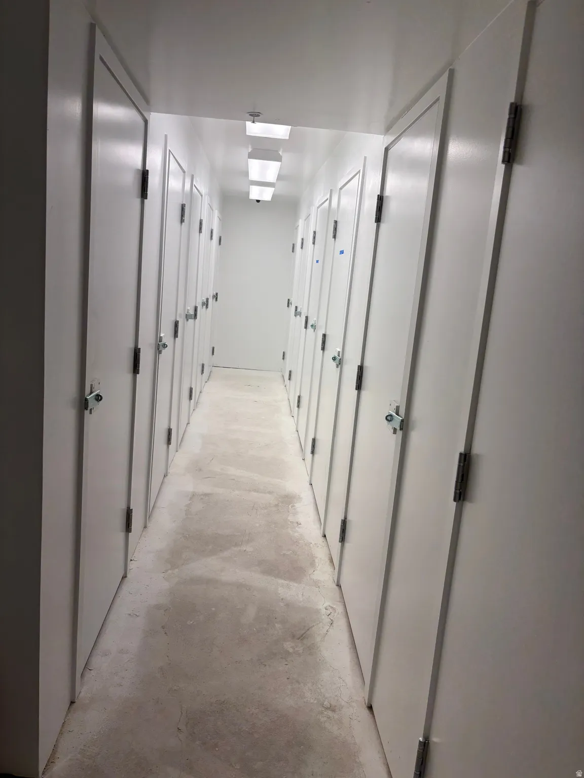 Corridor featuring concrete flooring