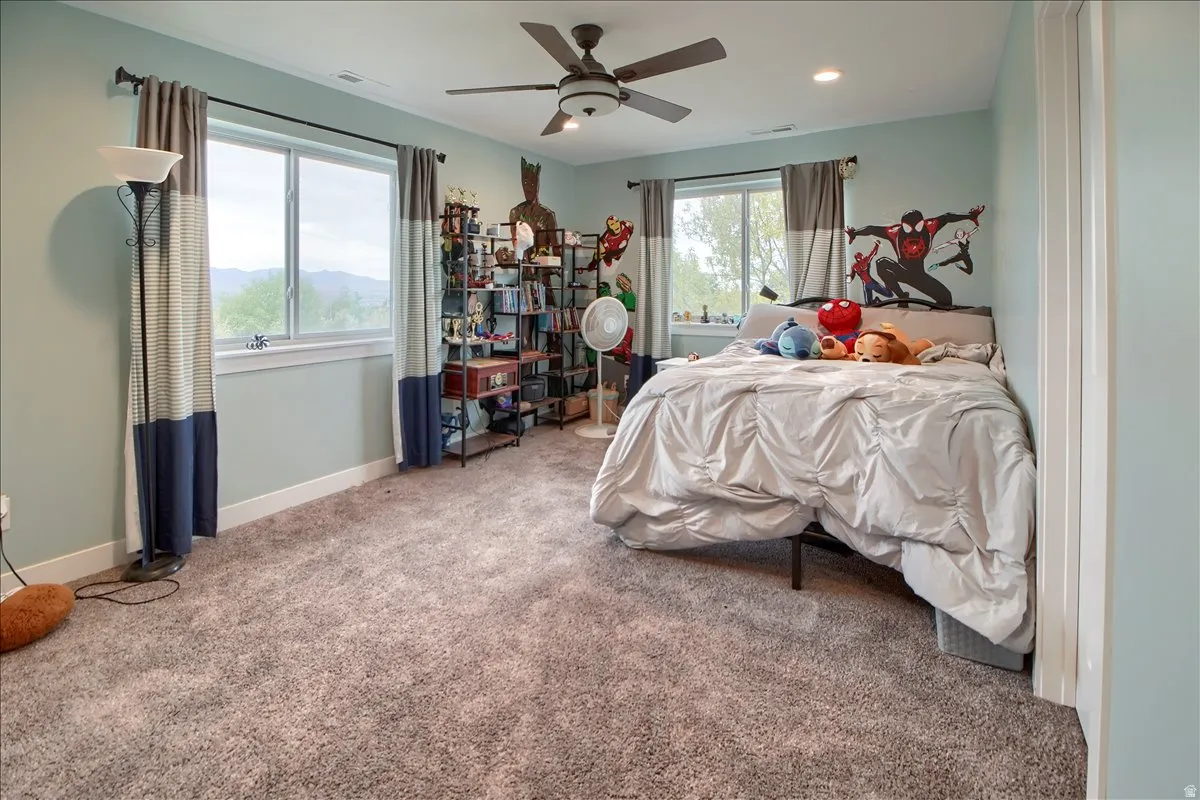 Bedroom with carpet and a ceiling fan