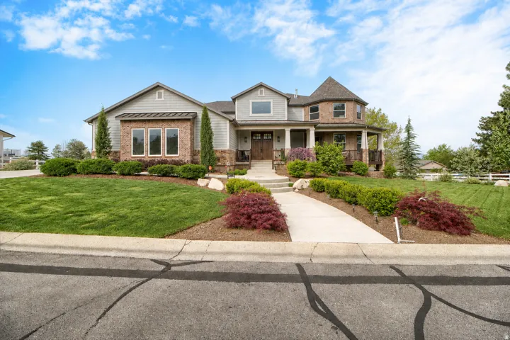 Two-story residence featuring a mixed material exterior, including siding and brick accents