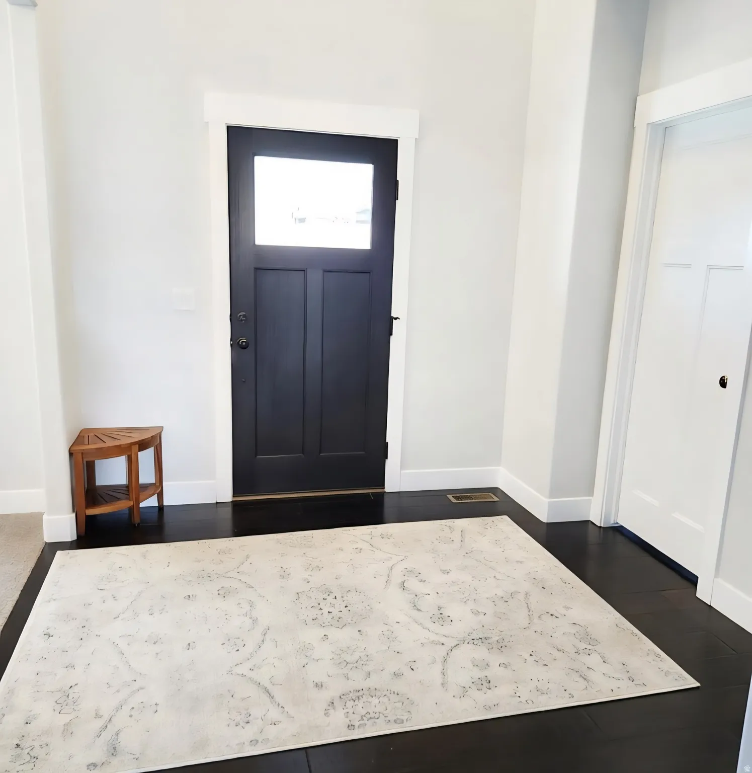 Foyer featuring dark wood-style flooring