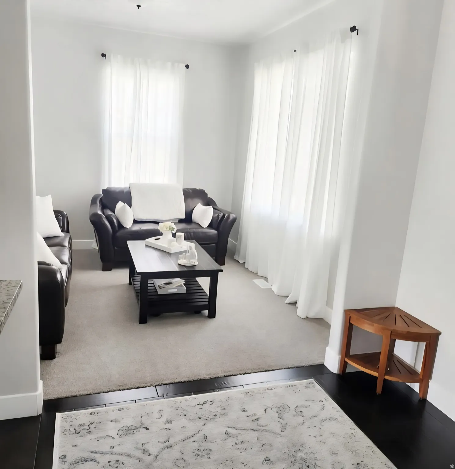 Living area featuring carpet and baseboards