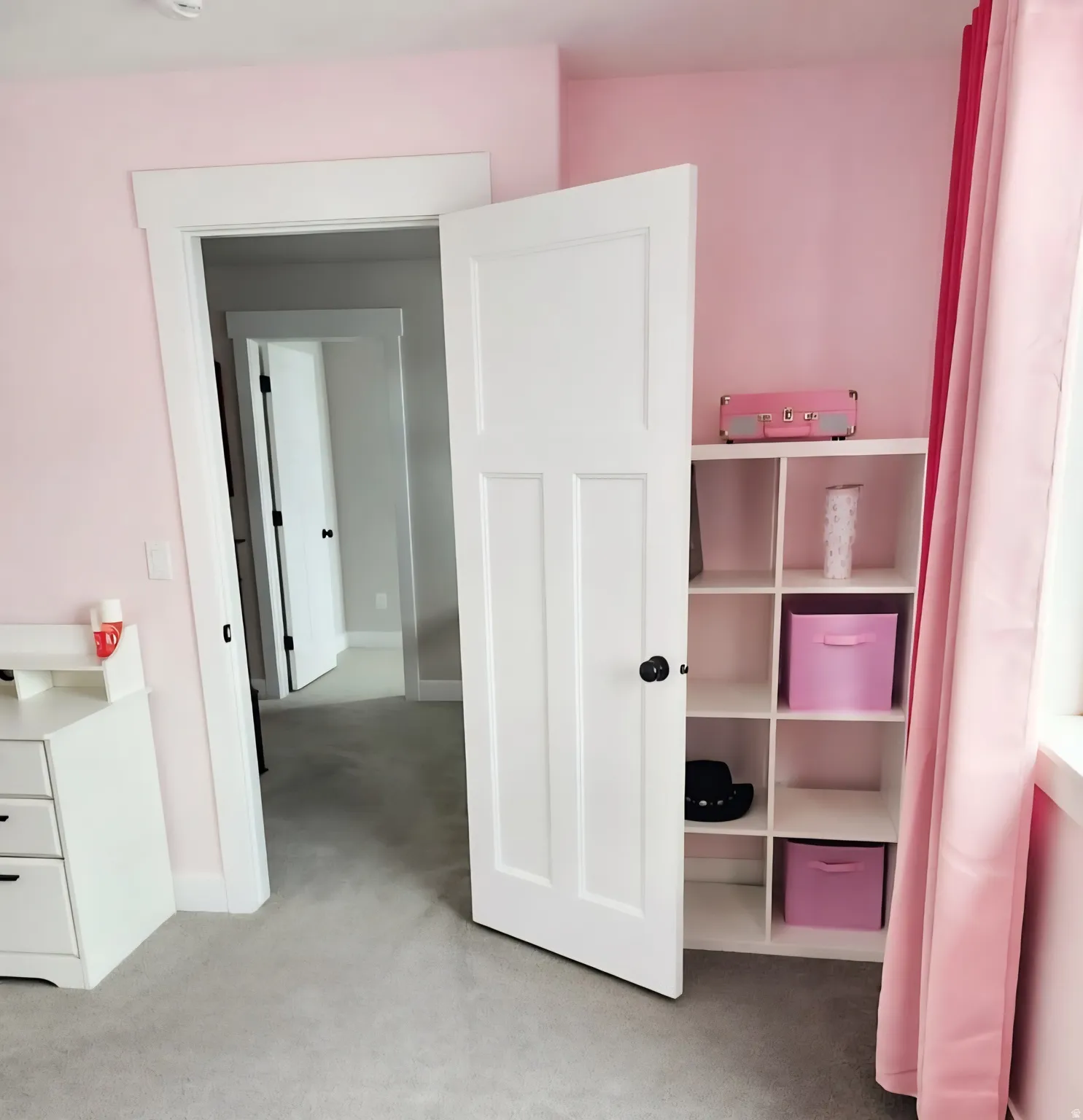 Room featuring light pink walls, light gray carpet, and white trim