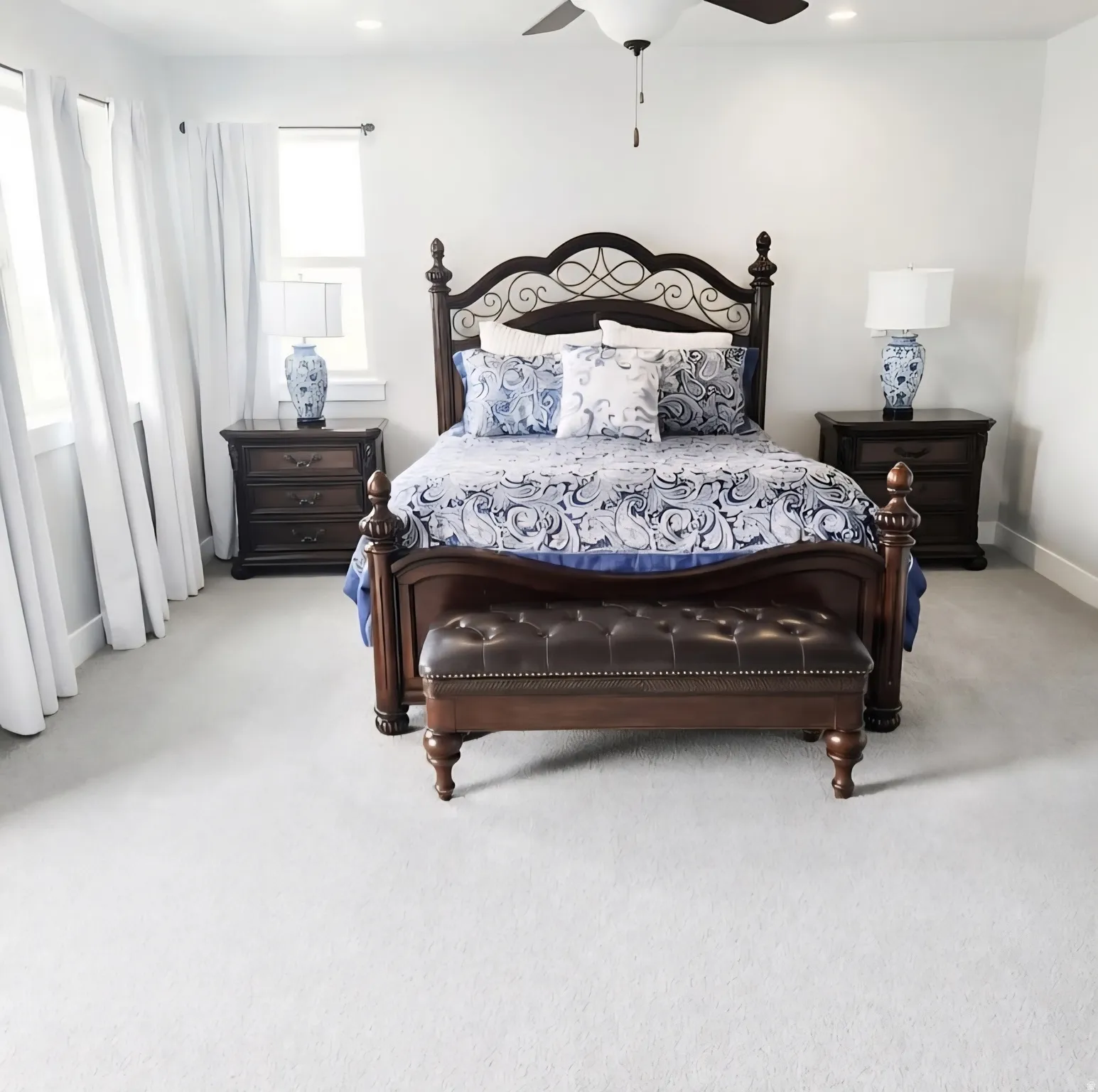 Spacious room featuring light-toned carpeting, recessed ceiling lighting, and a ceiling fan