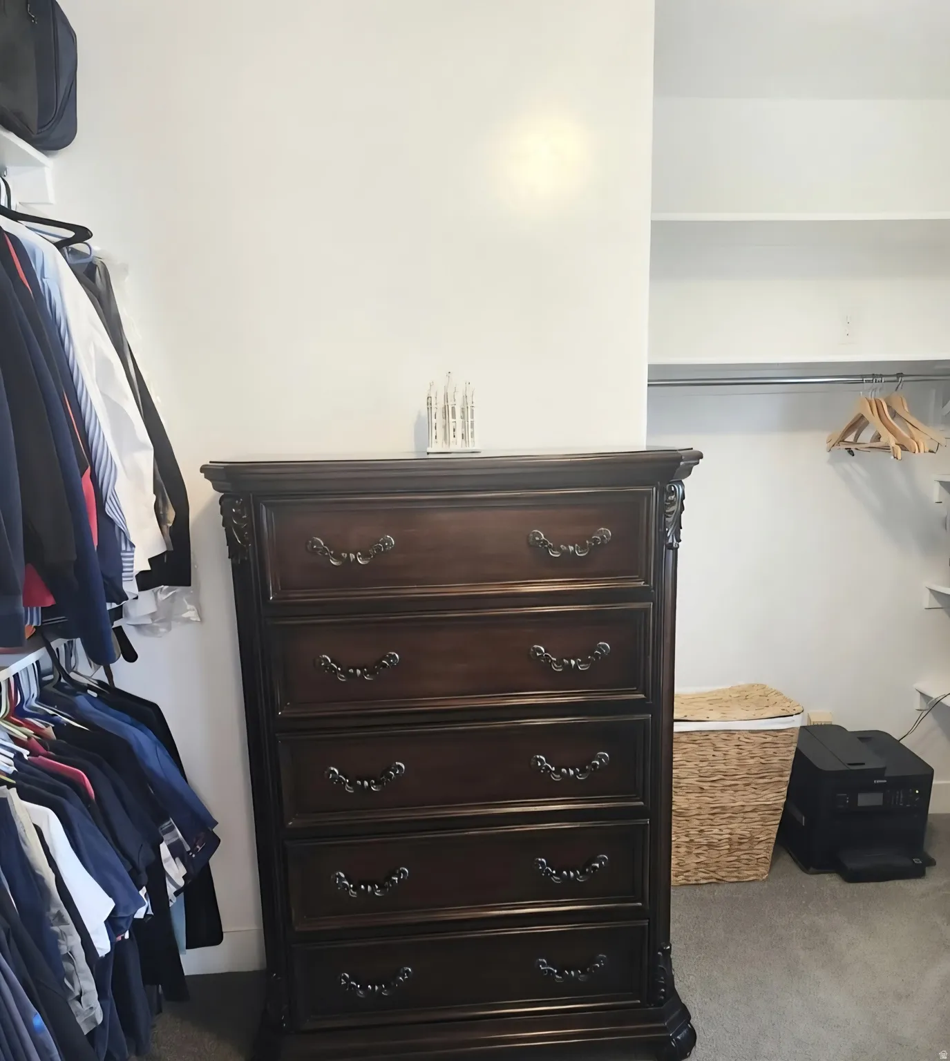 Integrated closet system featuring white shelving and hanging rods