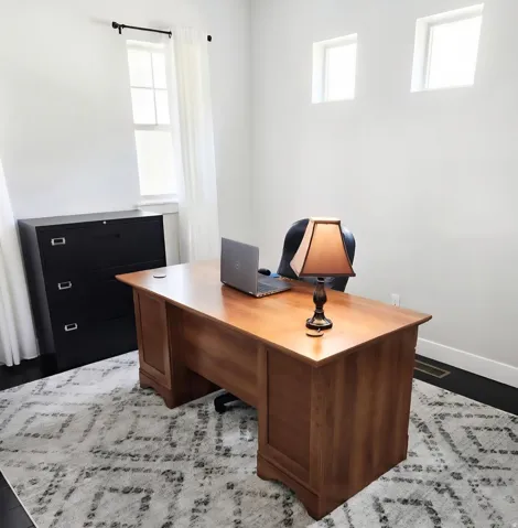 Office space with baseboards and wood finished floors