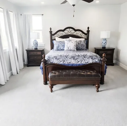 Spacious room featuring light-toned carpeting, recessed ceiling lighting, and a ceiling fan