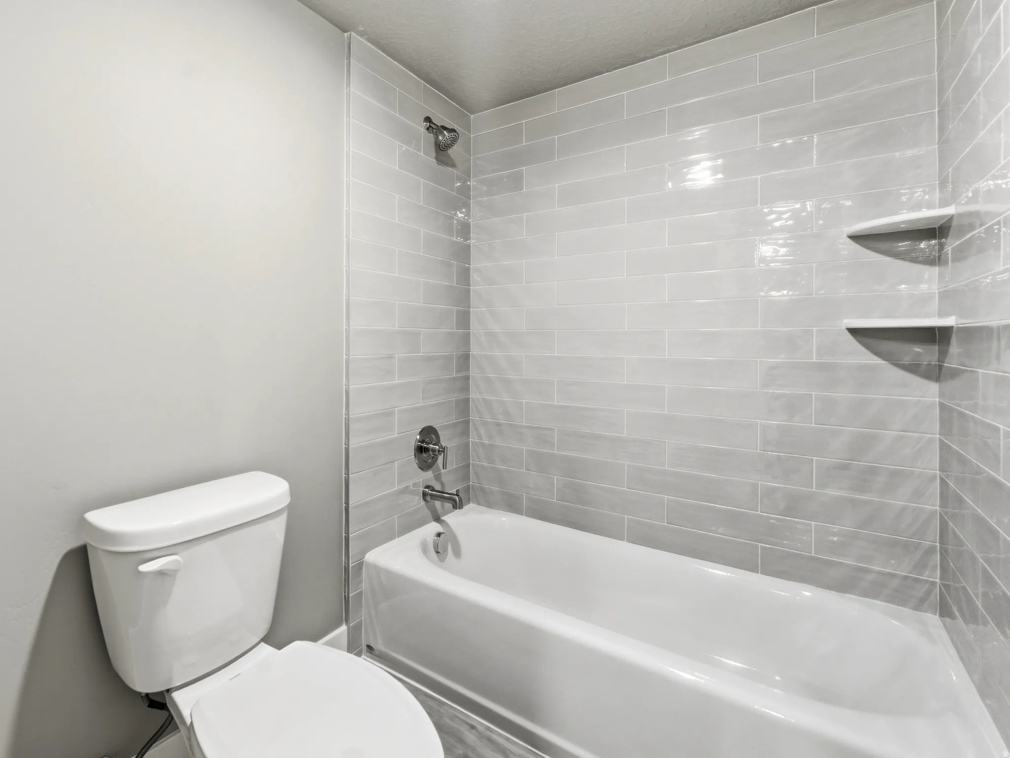 Full bathroom featuring toilet and bathtub / shower combination