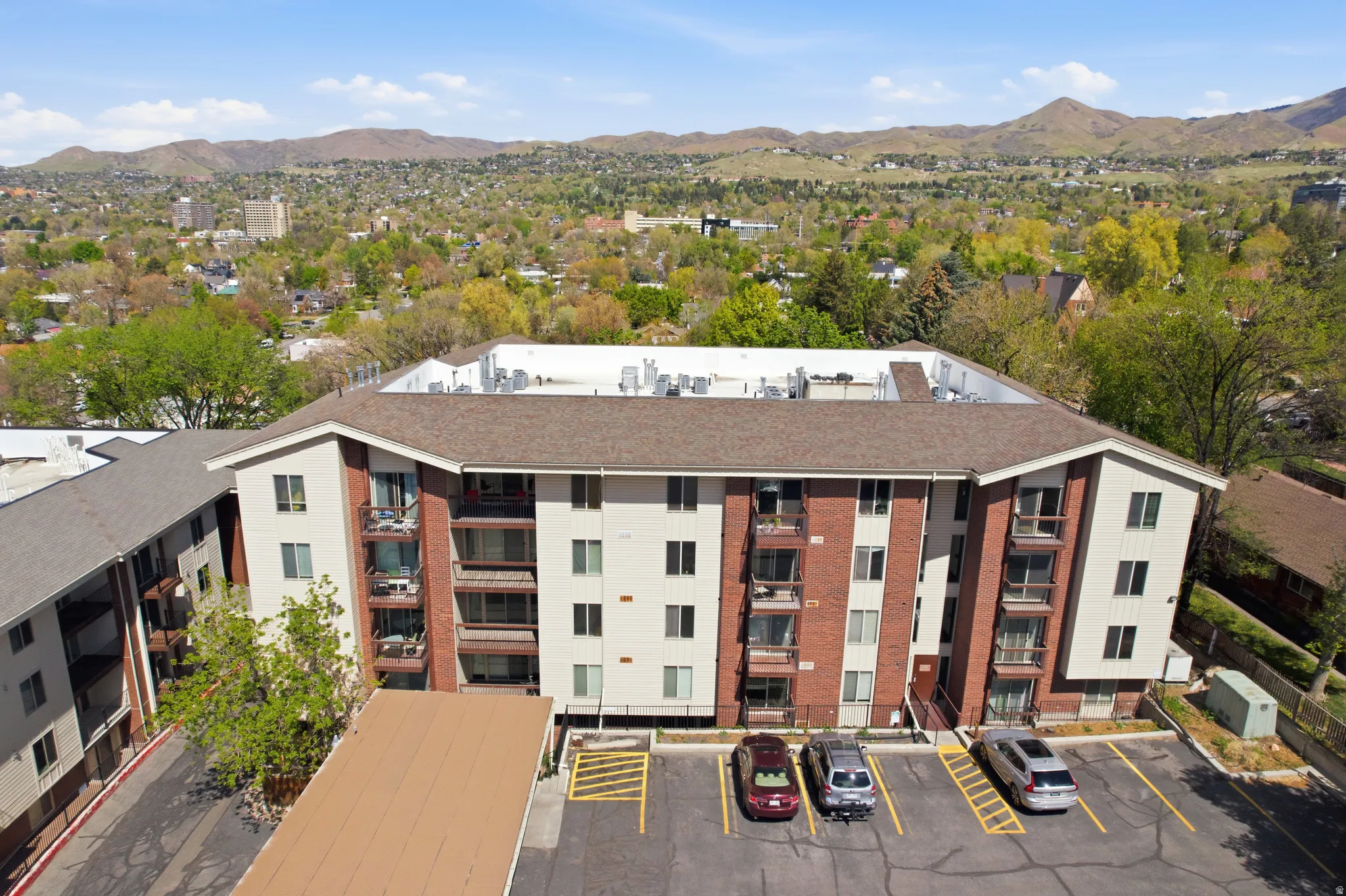 View of the building / complex featuring a mountain view and uncovered parking