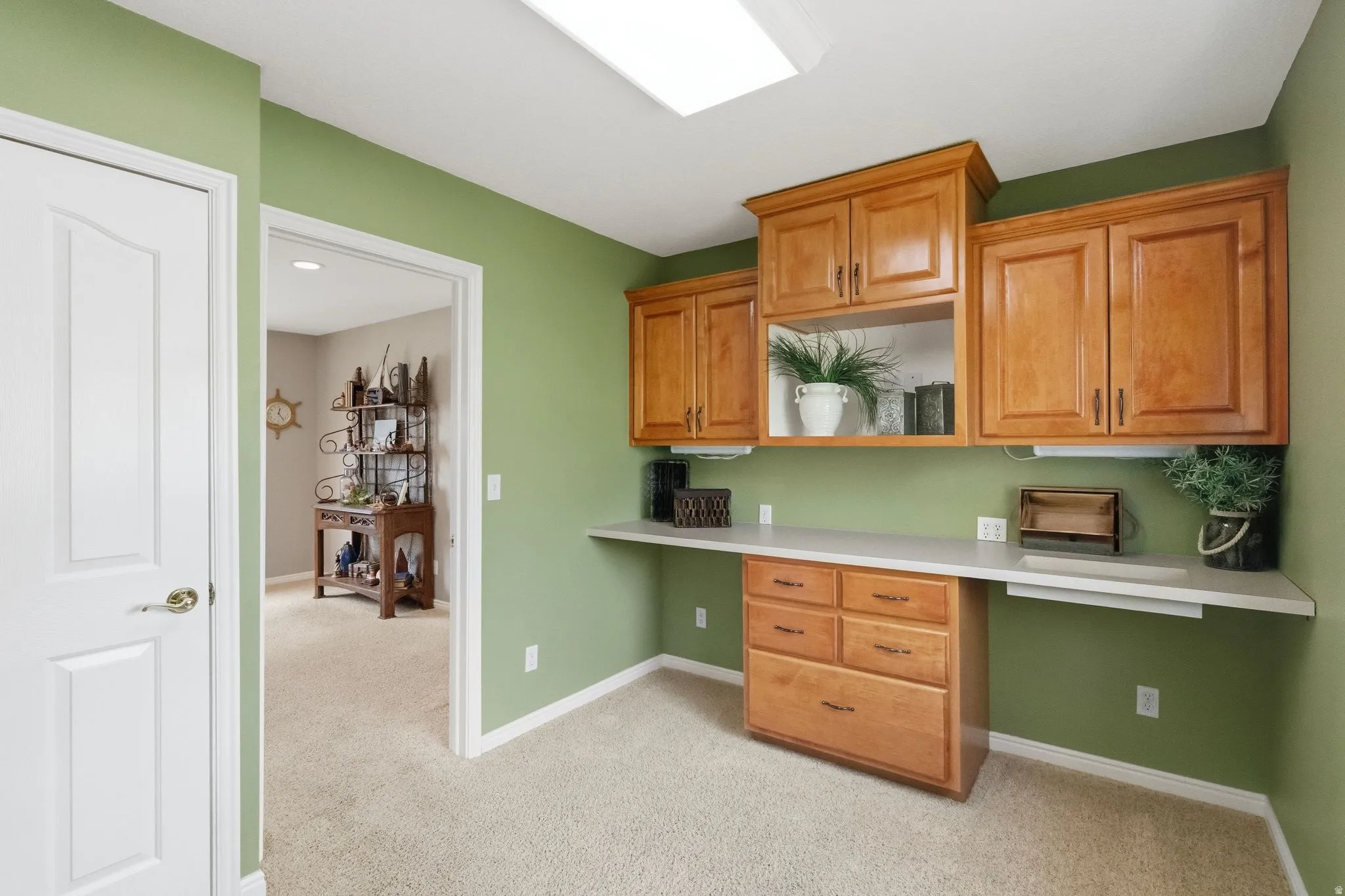 Versatile laundry room includes sink (not pictured), cabinetry, and counter space. View from washer and dryer space.