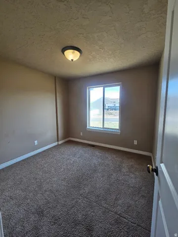 Master Bedroom Carpeted room featuring a single window with white trim, a semi-flush mount ceiling light, and neutral wall paint