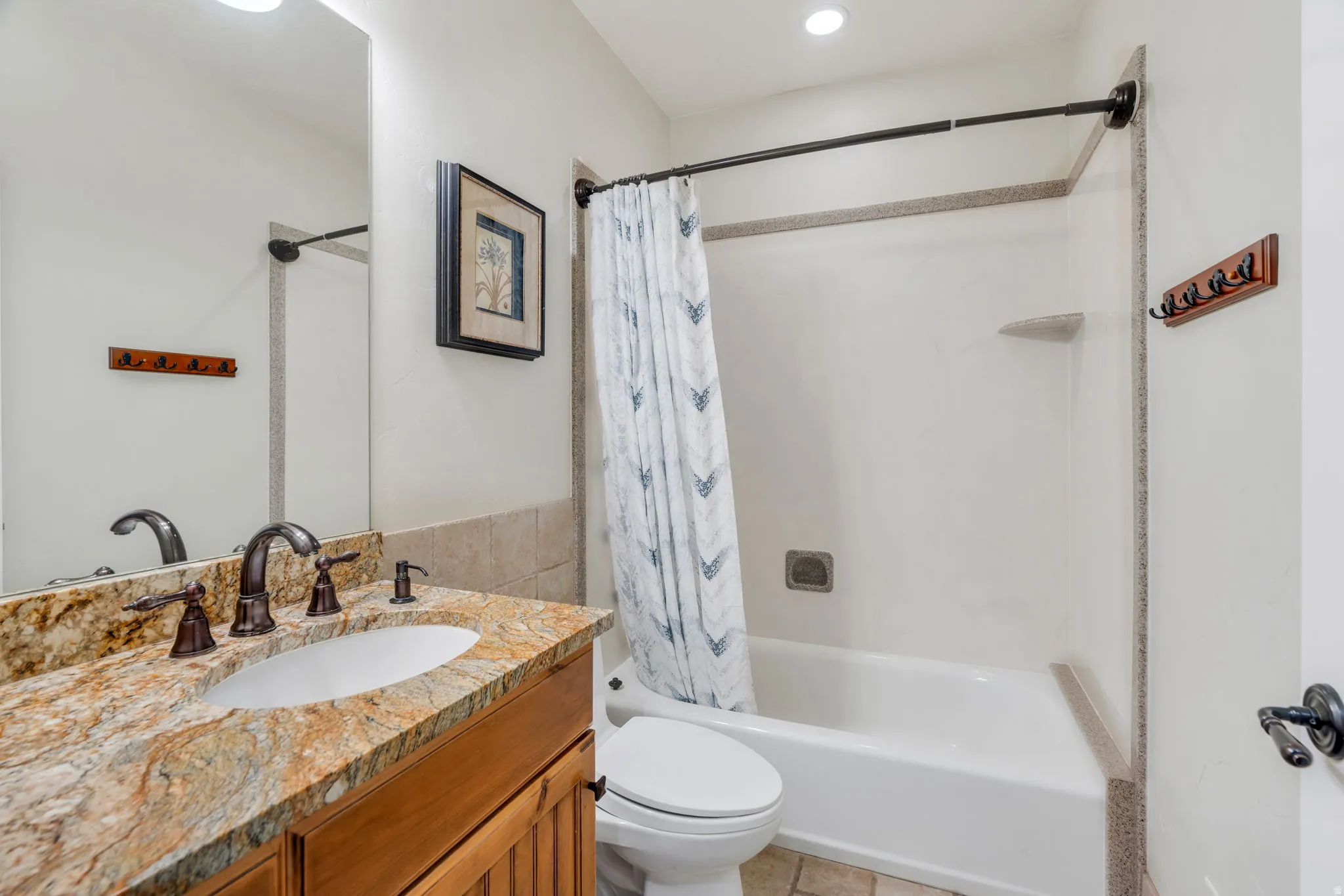 Bathroom with vanity and shower / bathtub combination with curtain