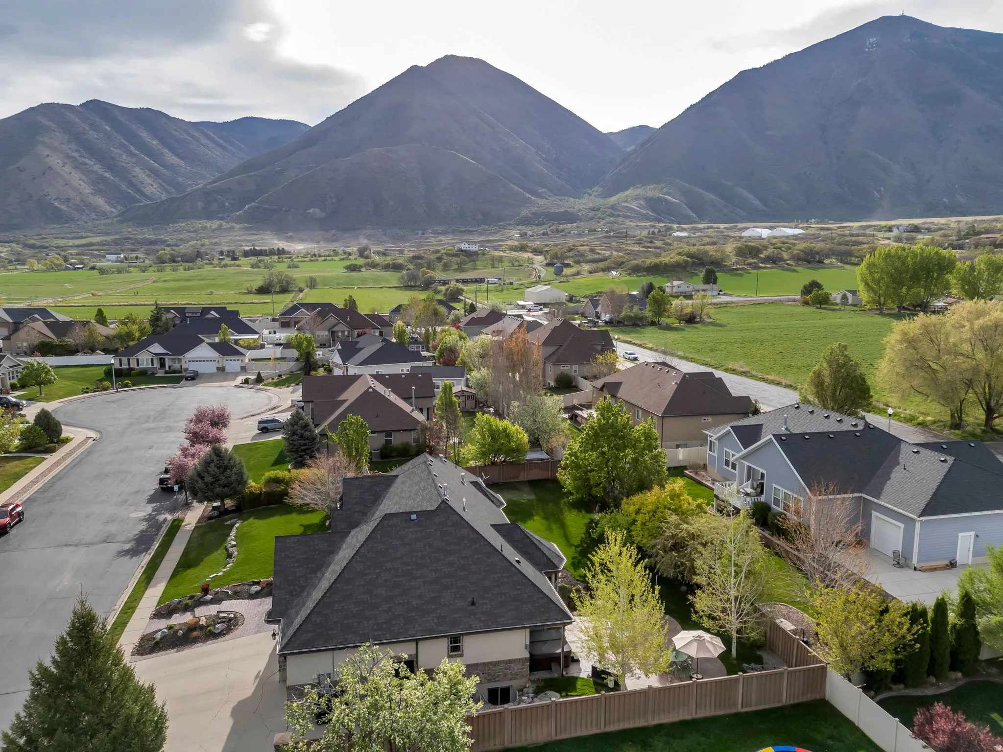 Aerial perspective of suburban area featuring a mountain backdrop