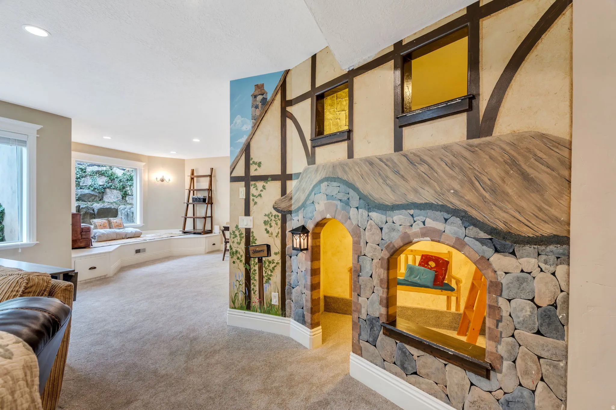 Carpeted living area with recessed lighting and baseboards