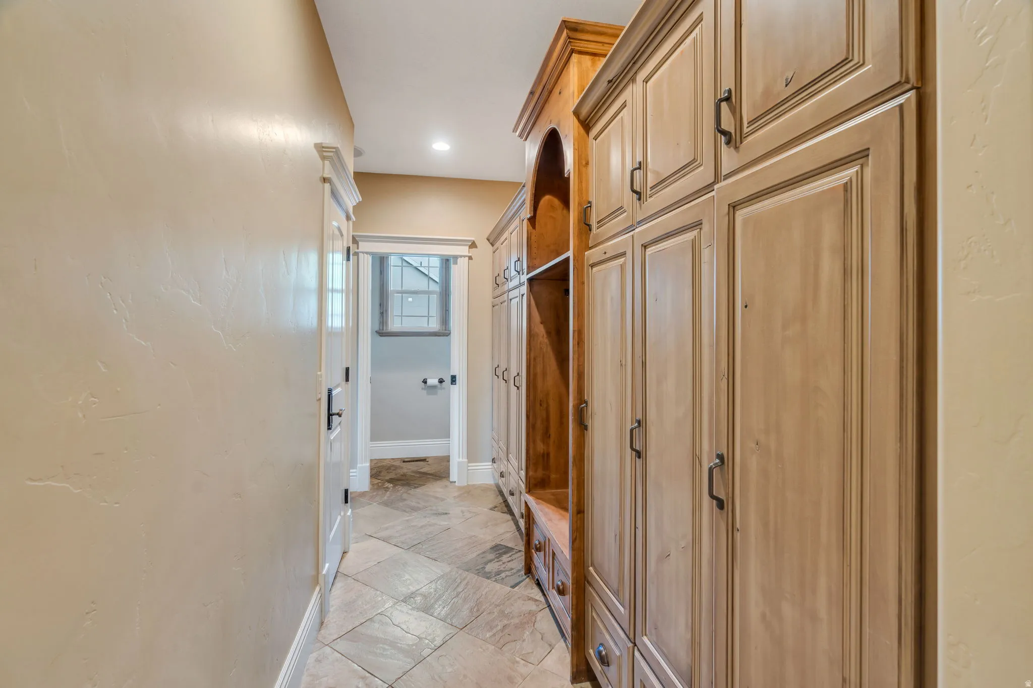 Mudroom with stone tile flooring and recessed lighting