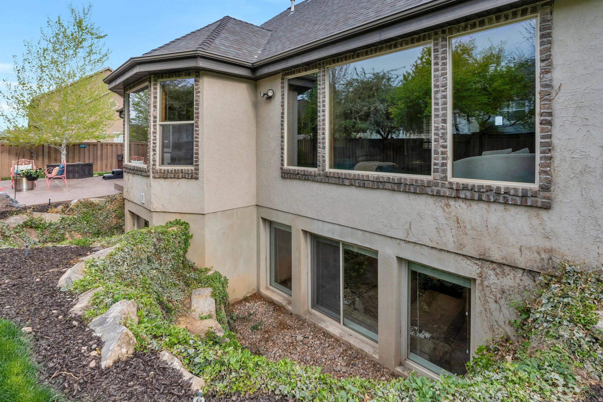 View of side of property with stucco siding and a patio