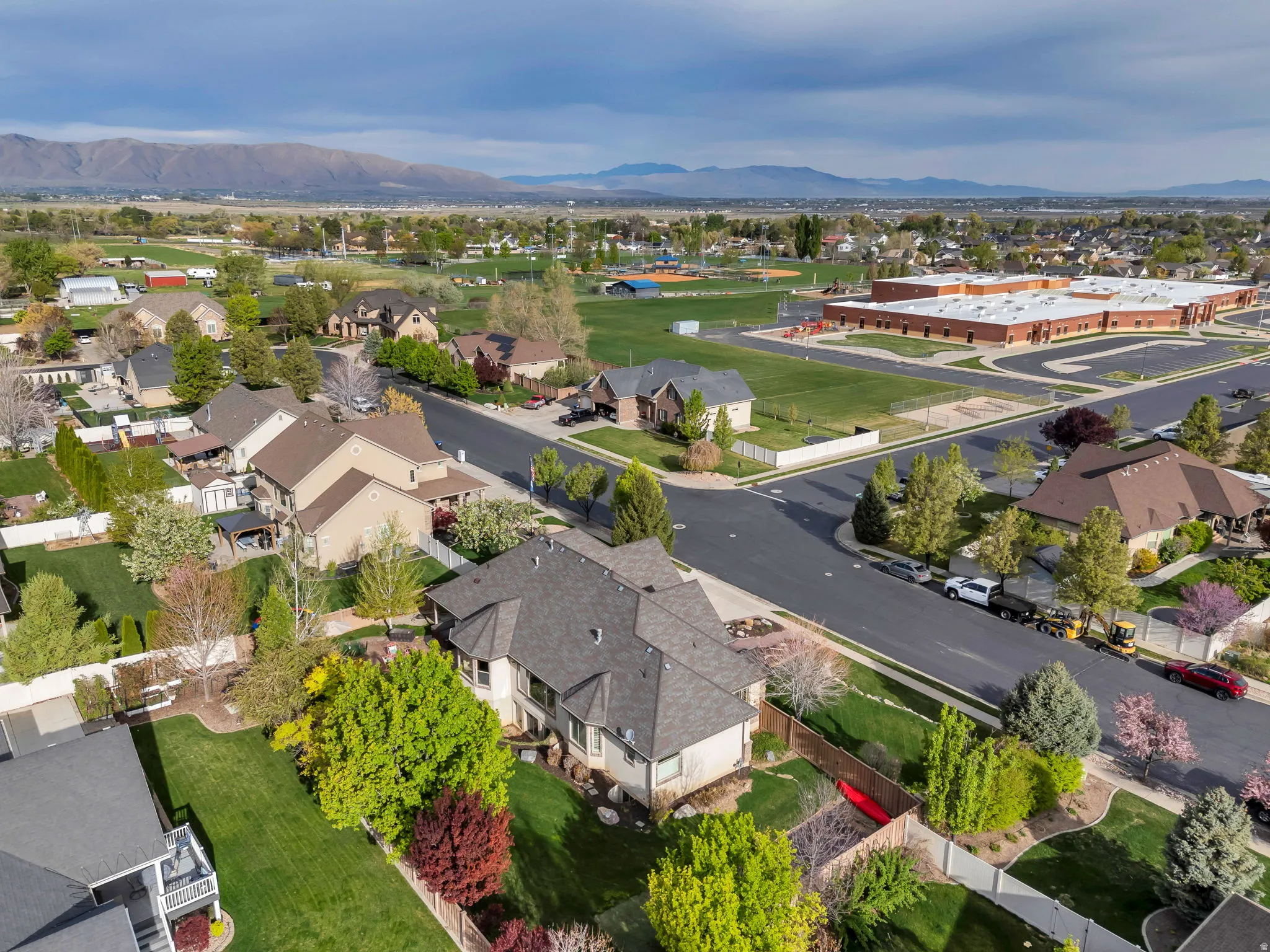 Aerial overview of property's location with a mountainous background and nearby suburban area