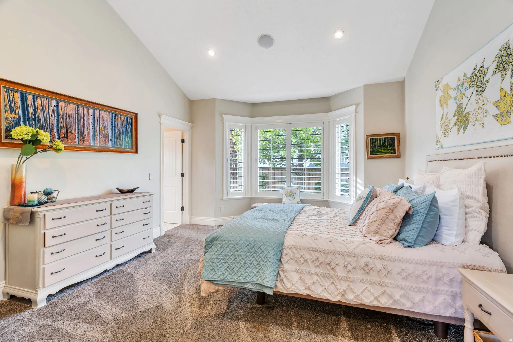 Bedroom with vaulted ceiling, light colored carpet, and recessed lighting
