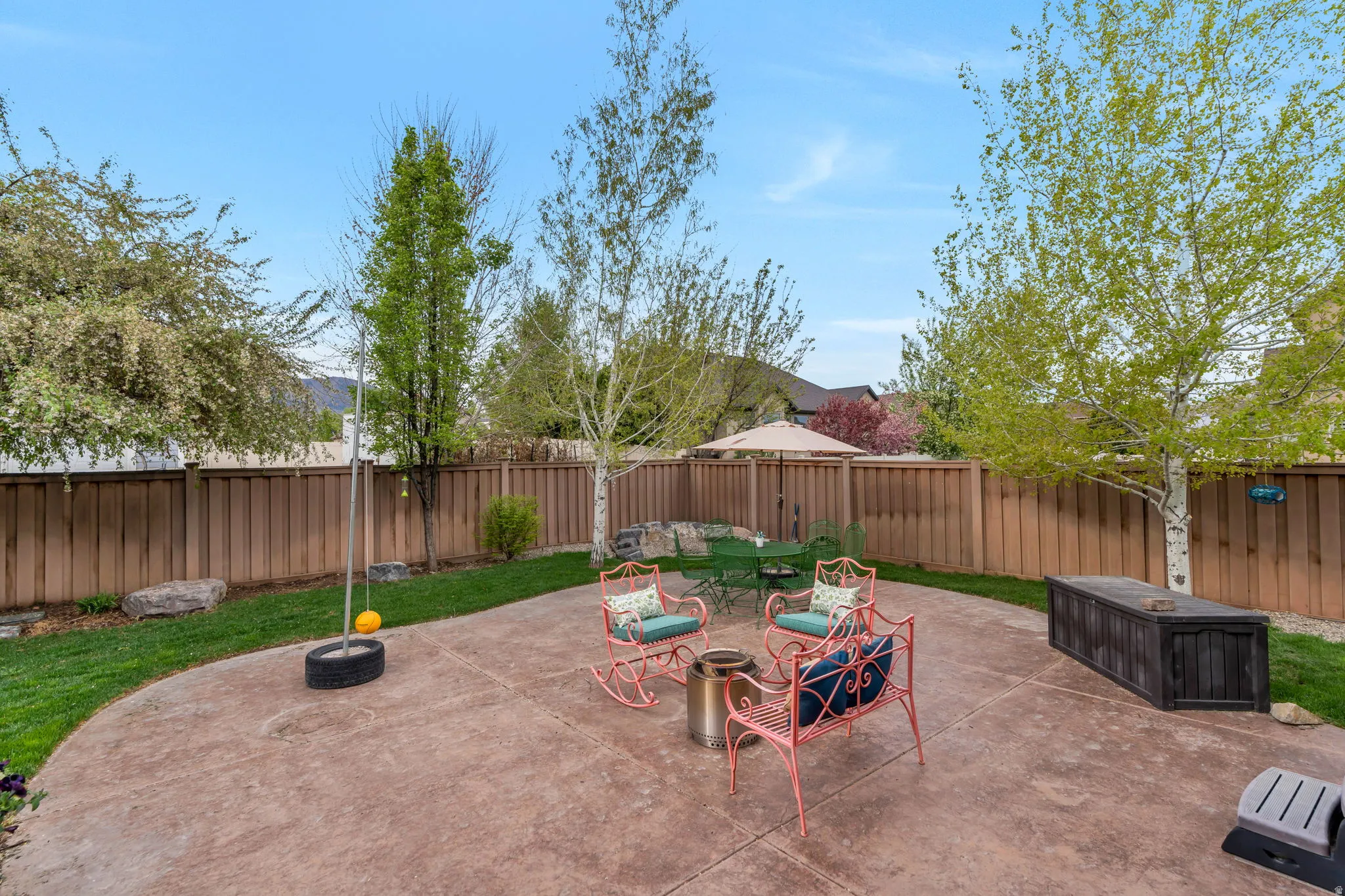 Fenced backyard with a patio and outdoor dining area