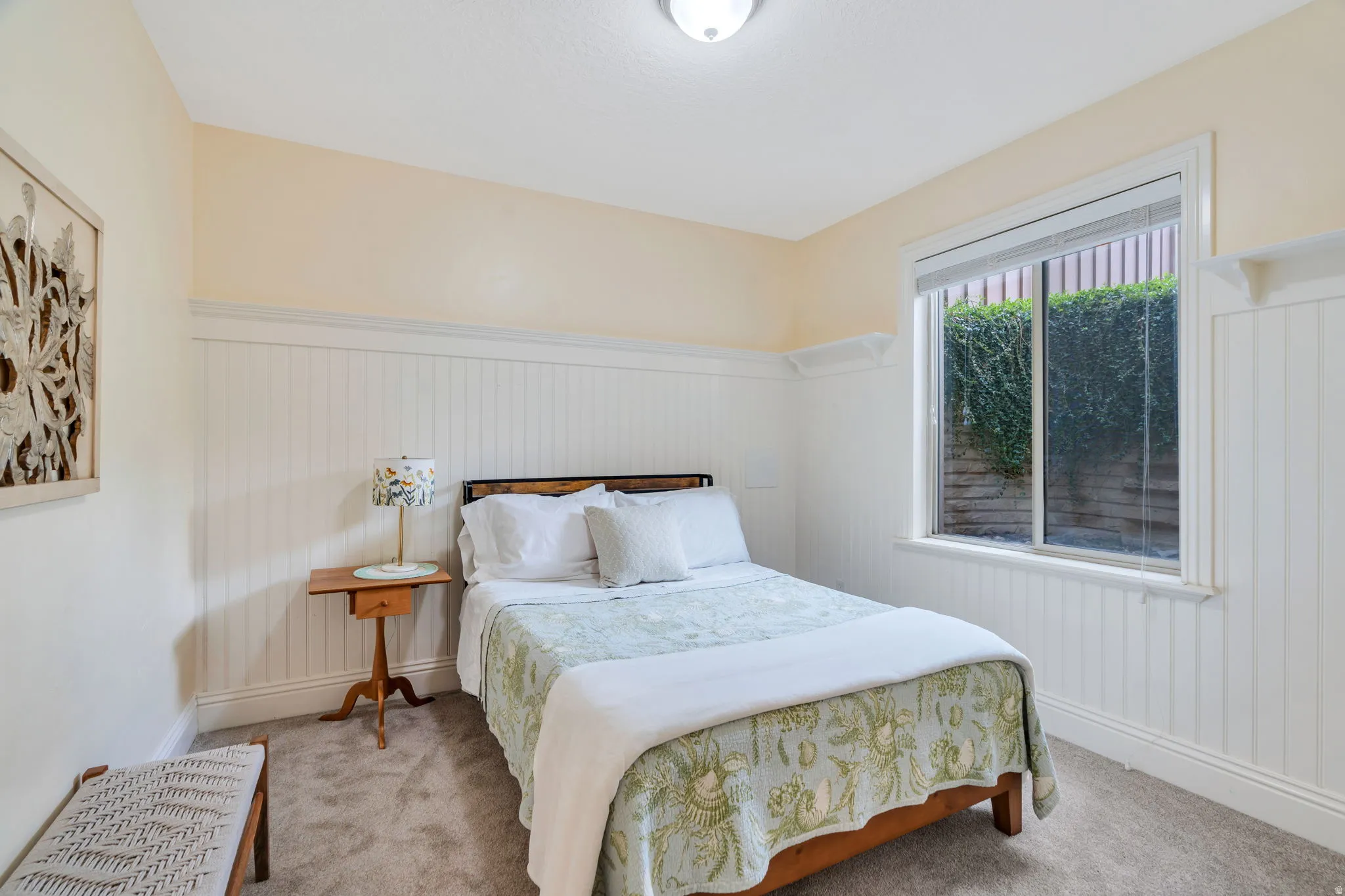 Bedroom featuring wainscoting and carpet floors