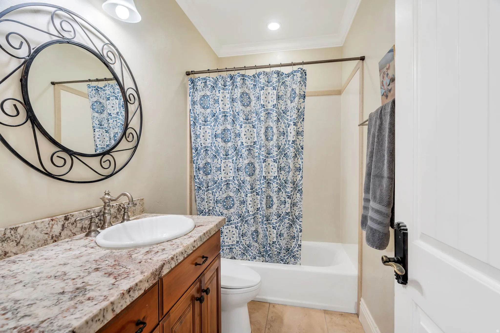 Full bathroom with vanity, shower / bath combo with shower curtain, crown molding, recessed lighting, and light tile patterned floors