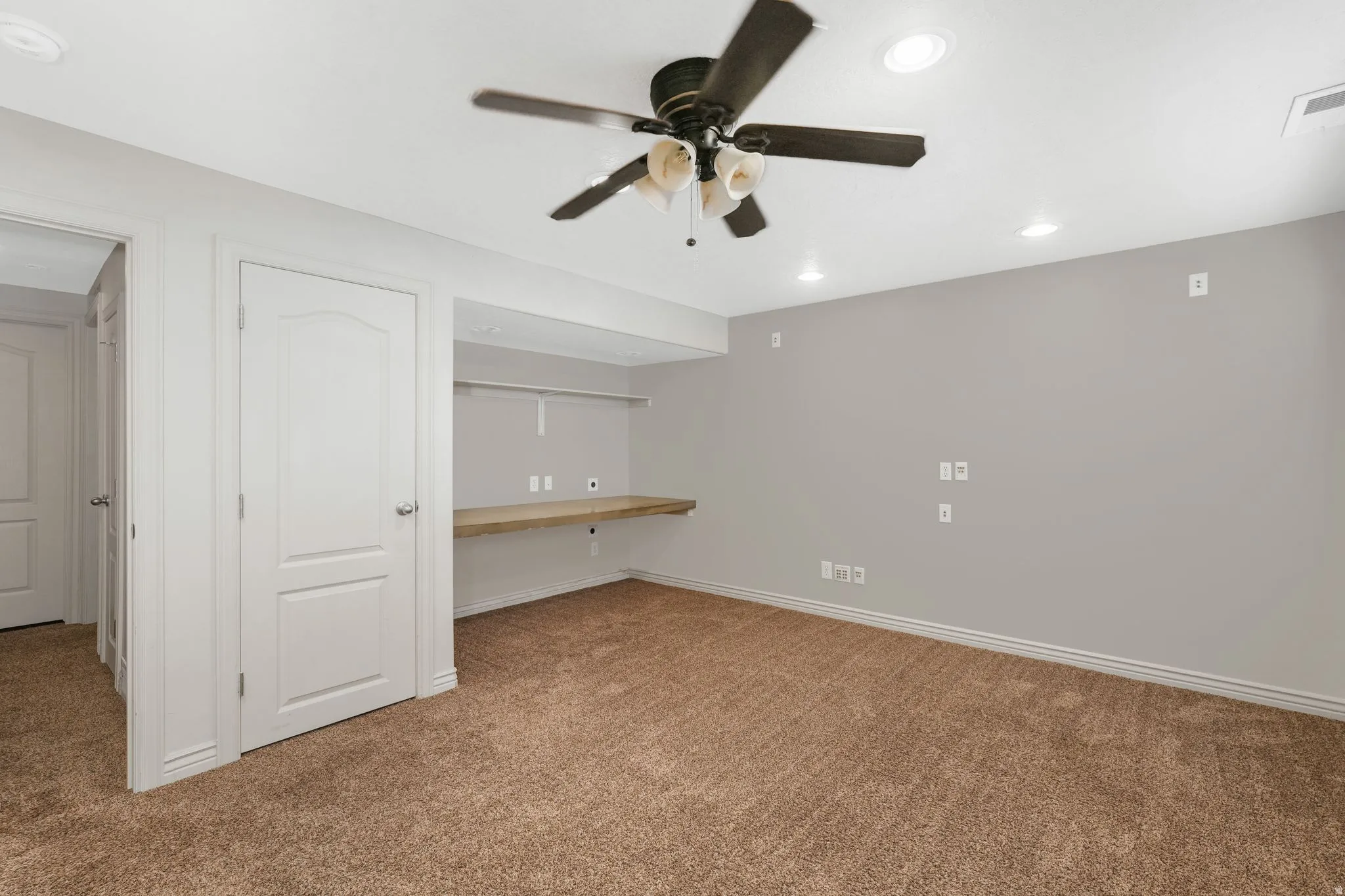 4th bedroom featuring built in study area, carpet, recessed lighting, and a ceiling fan