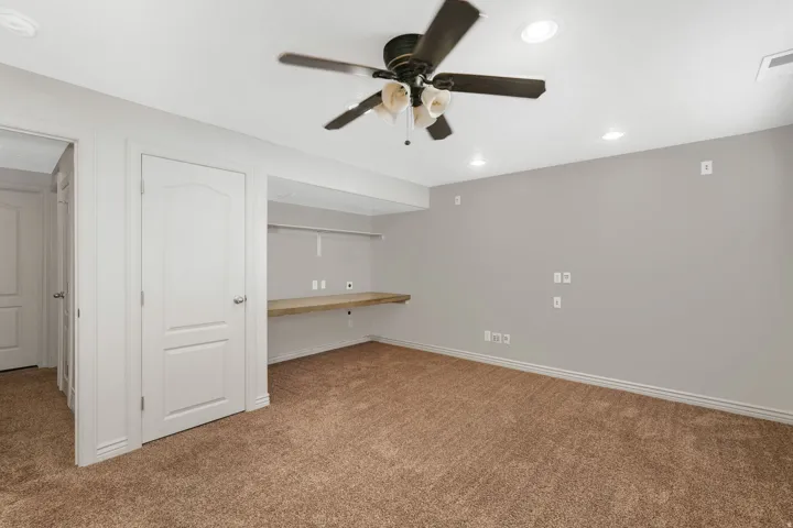 4th bedroom featuring built in study area, carpet, recessed lighting, and a ceiling fan