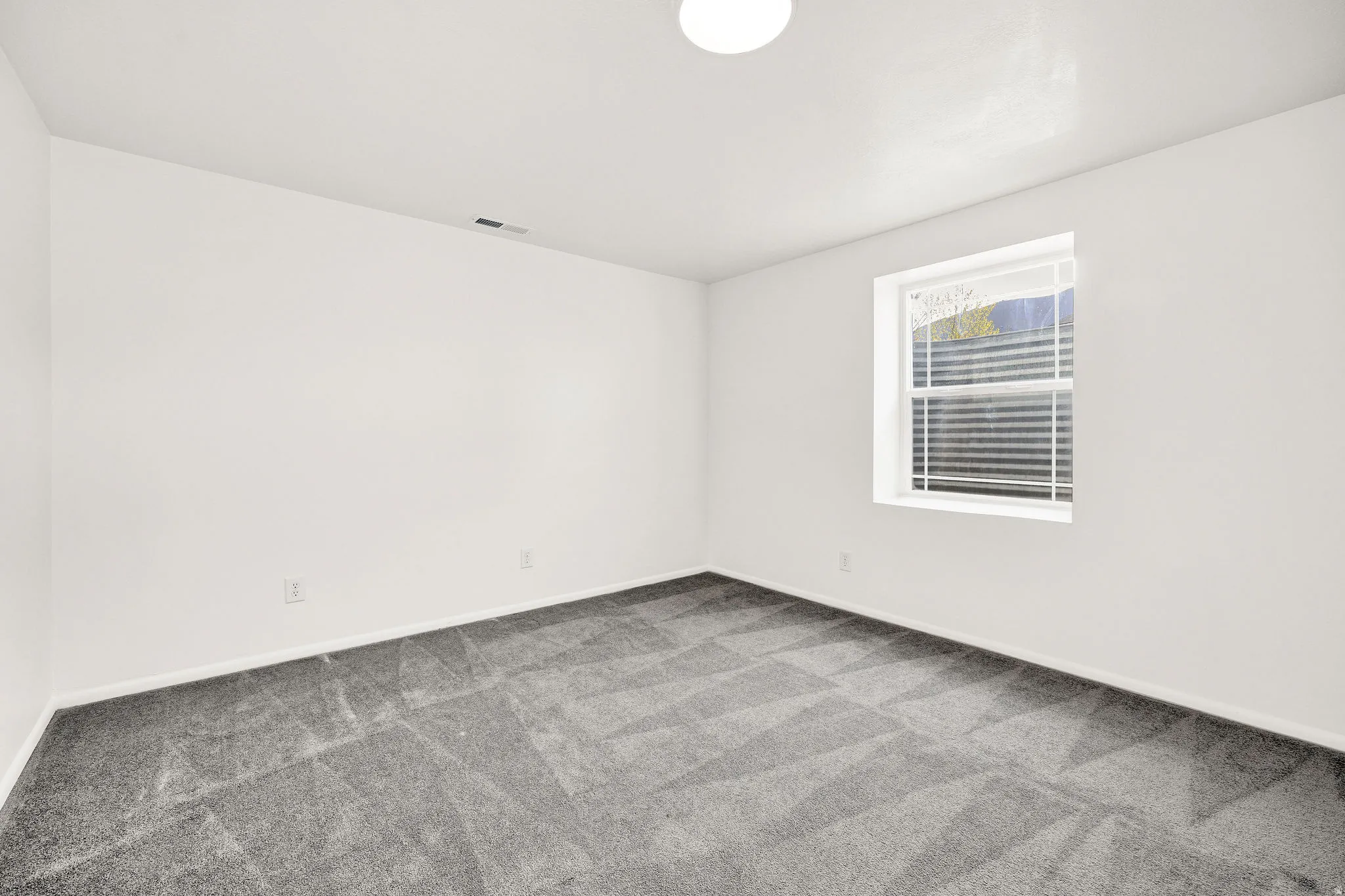 Spare room featuring light carpet