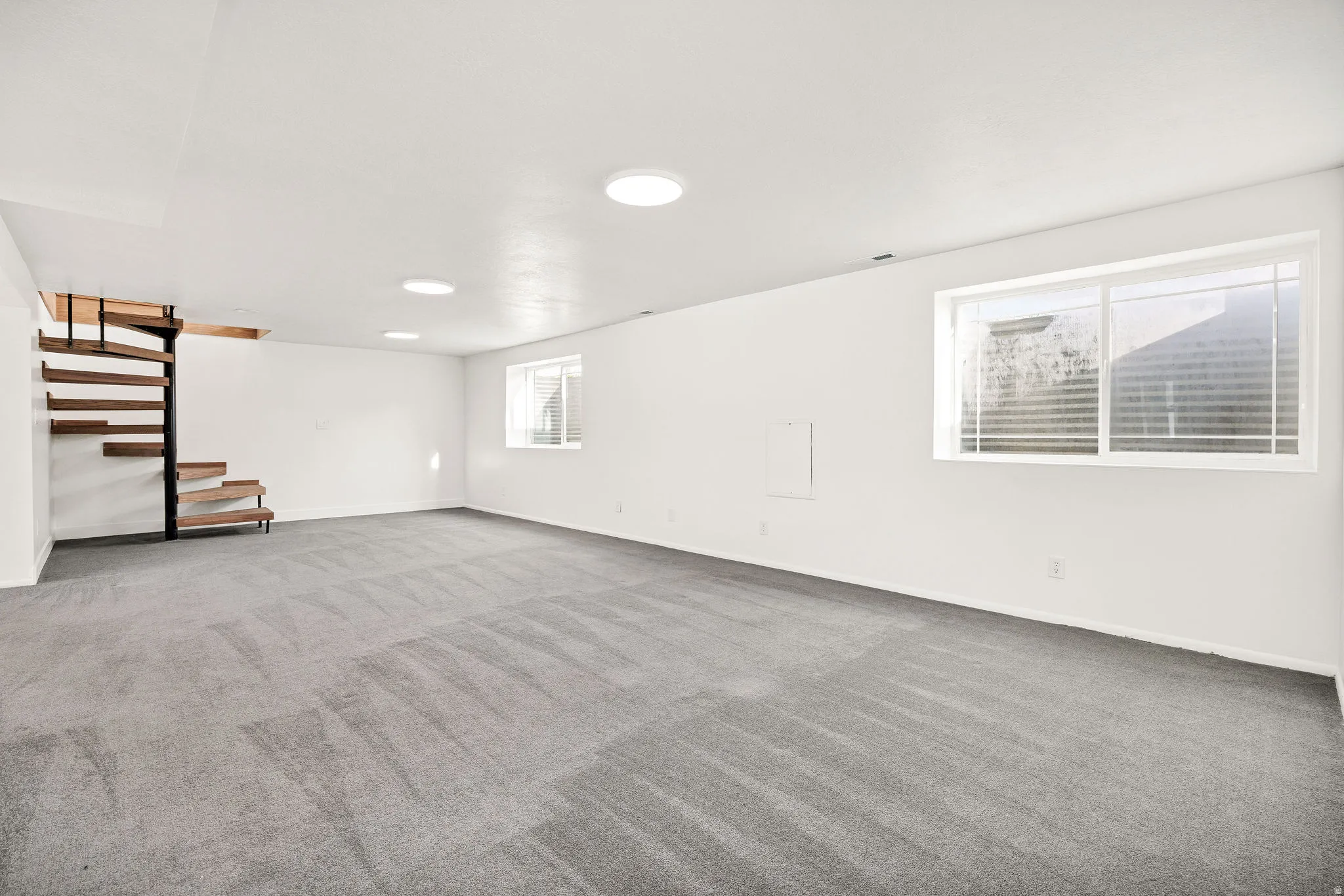 Basement with stairs and carpet floors