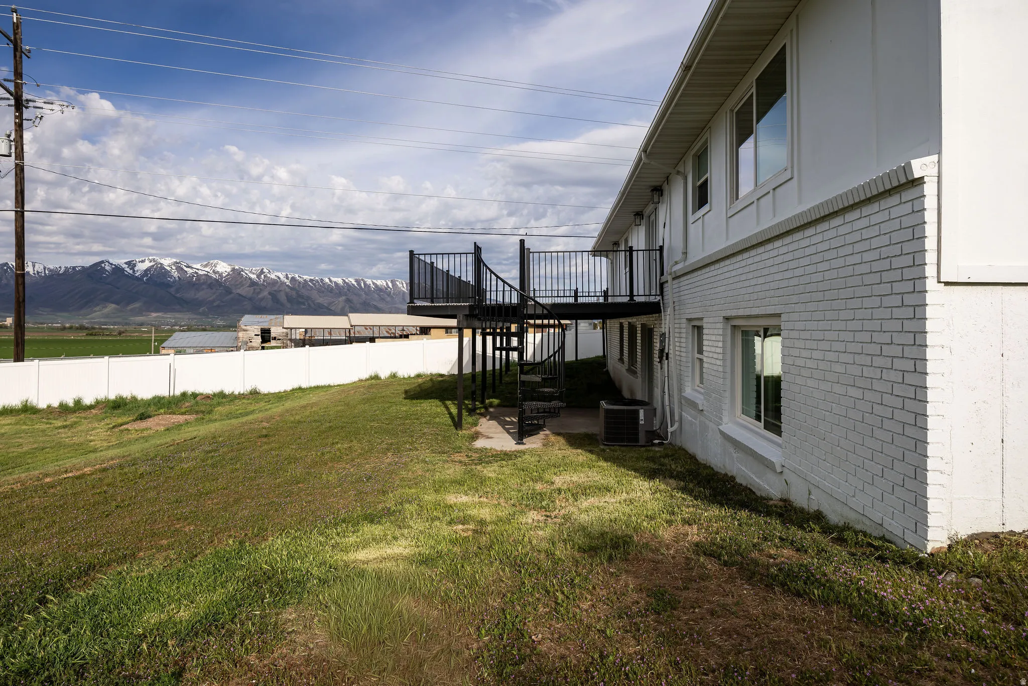 View of yard featuring a patio and a deck with mountain view