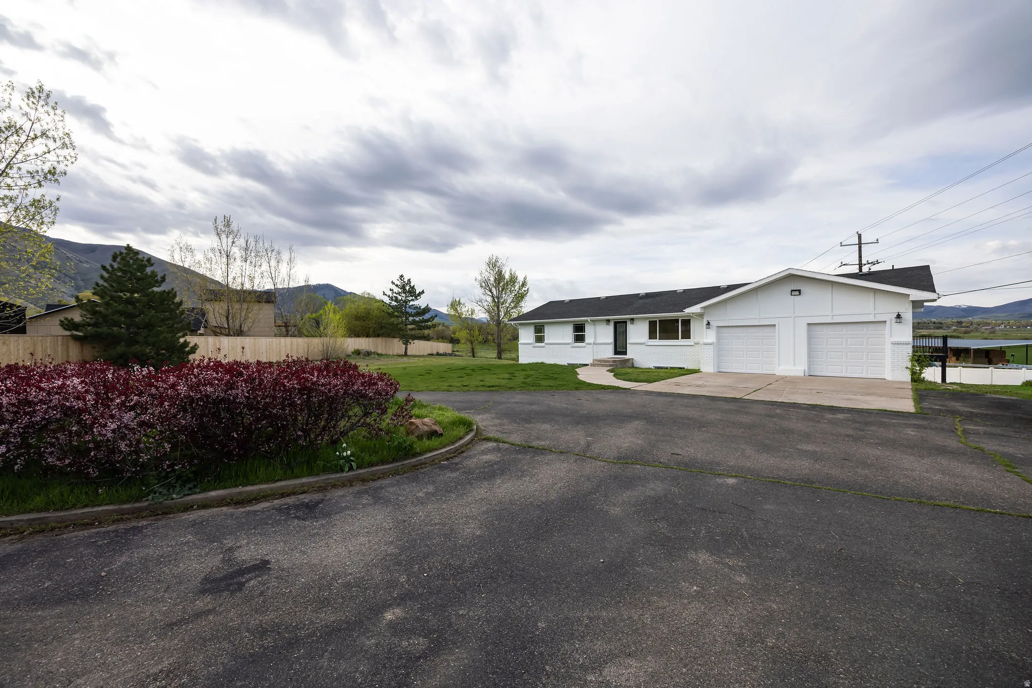 Ranch-style house featuring driveway, a mountain view, and a garage