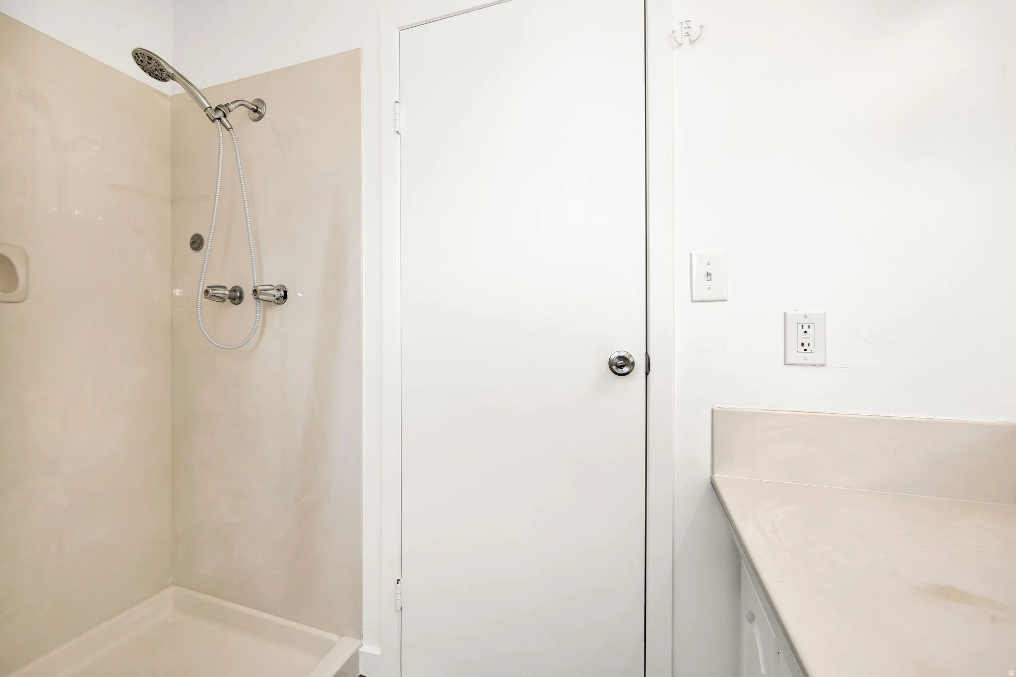 Bathroom featuring a shower stall and vanity