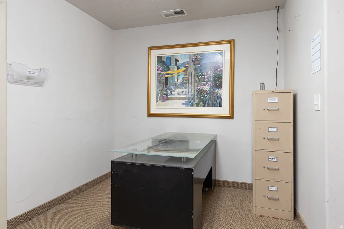 Carpeted office with baseboards