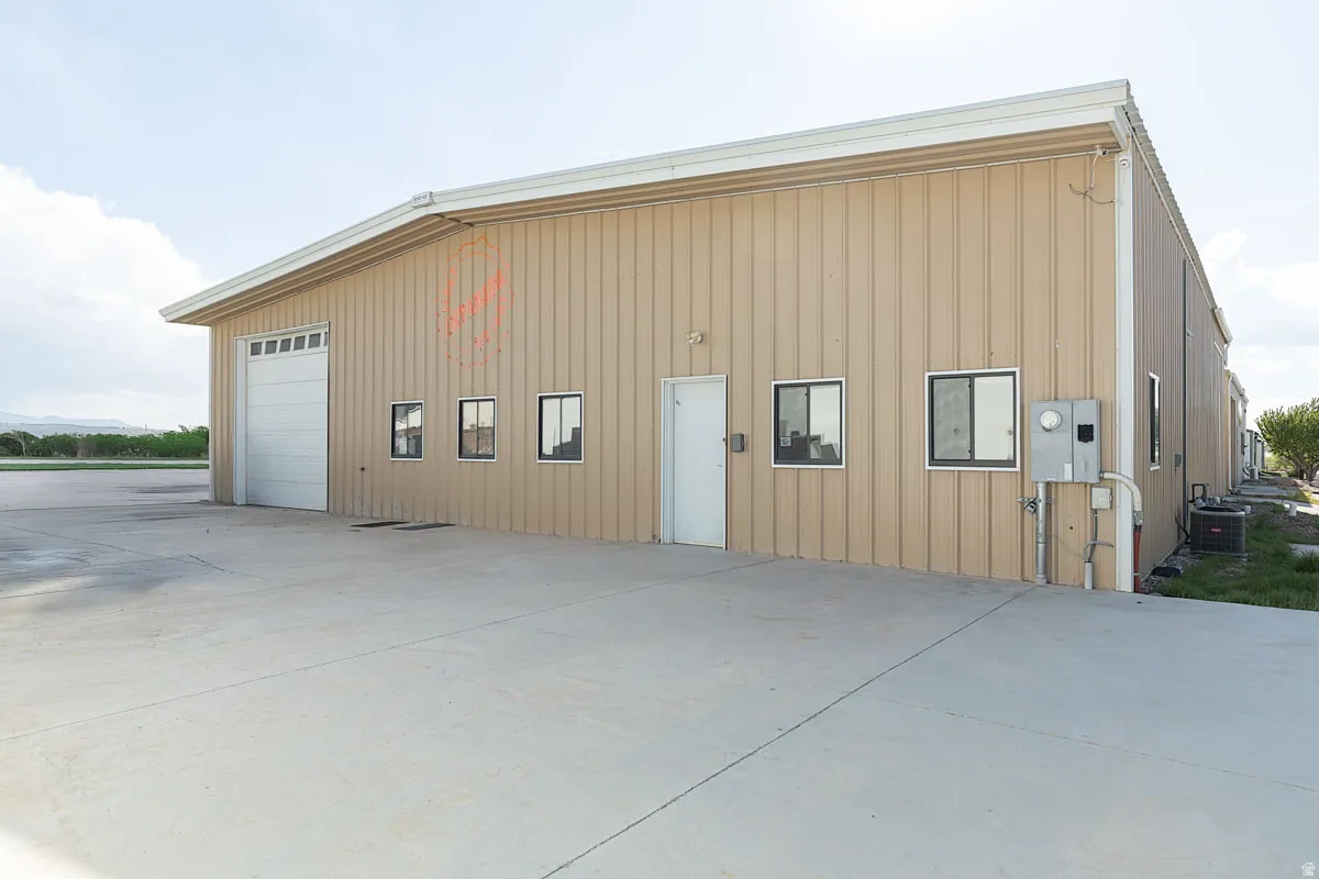 View of outdoor structure with concrete driveway