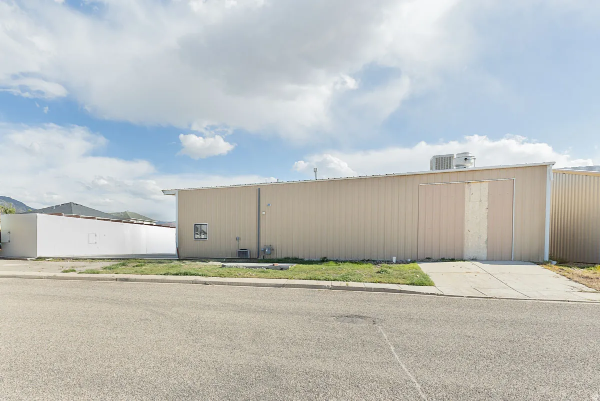 View of home's exterior featuring an outbuilding and a pole building