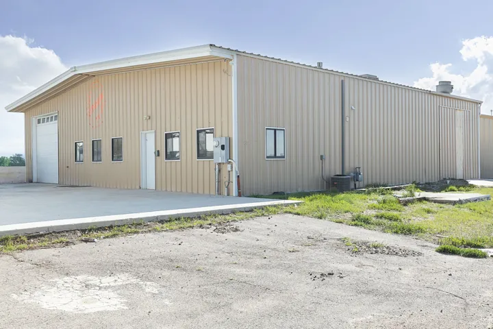 View of building exterior featuring a detached garage