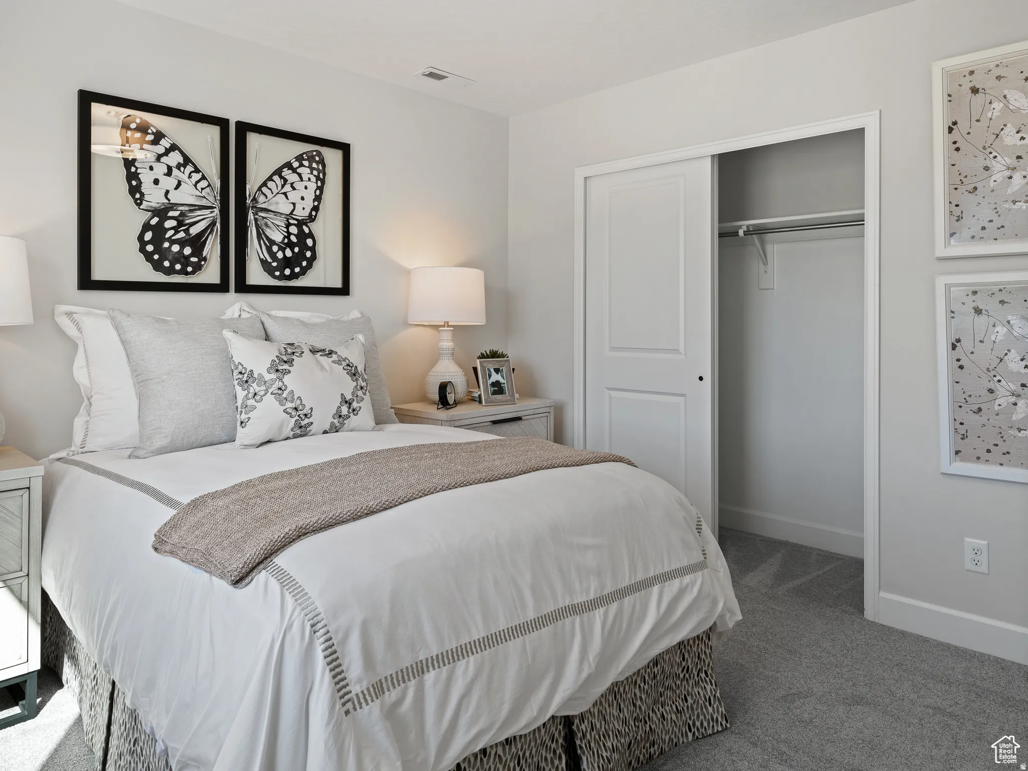 Carpeted bedroom with baseboards and a closet