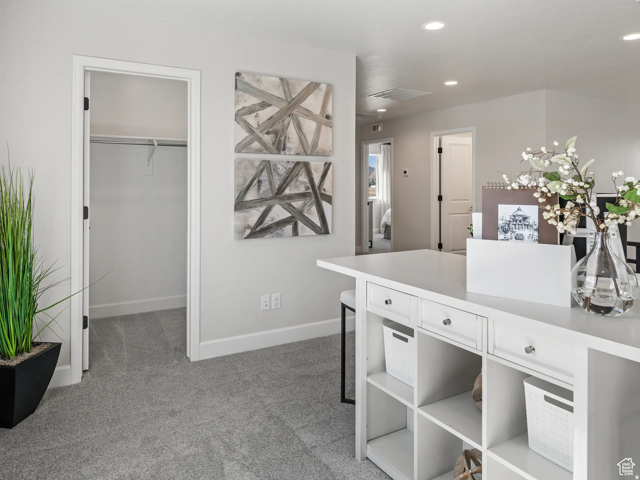 Home office with light carpet and recessed lighting