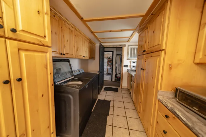 Laundry room featuring cabinet space, light tile patterned floors, and independent washer and dryer