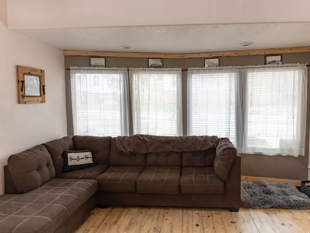 Living area featuring light wood finished floors and a textured ceiling