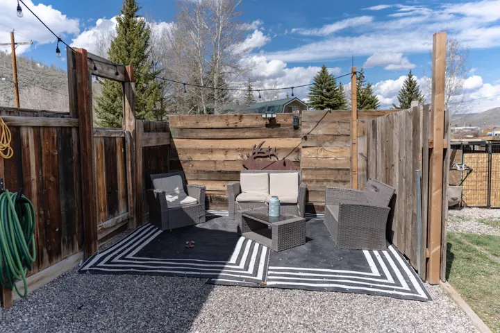 Fenced backyard with a patio, an outdoor lounge area, and a mountain view