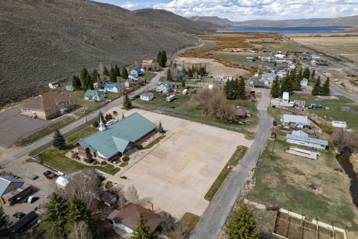 Aerial view of property's location featuring nearby suburban area and a water and mountain view
