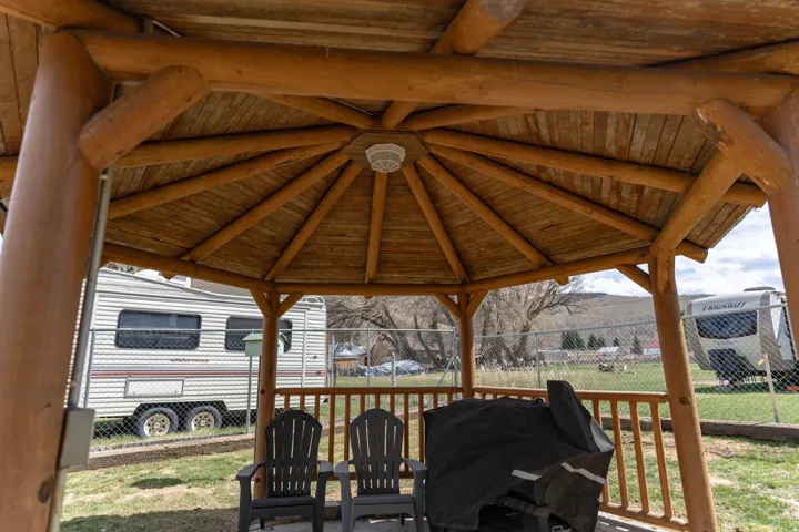 Wooden deck with grilling area, a gazebo, and a mountain view