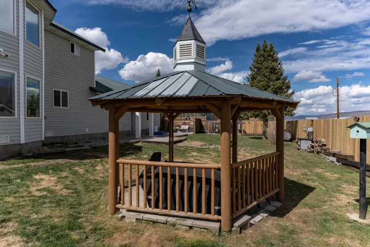 Deck featuring a gazebo, a patio area, and oil tank