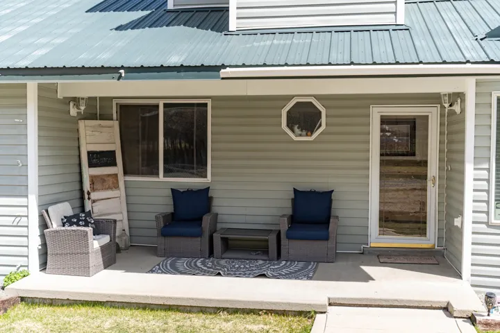 View of exterior entry featuring a metal roof