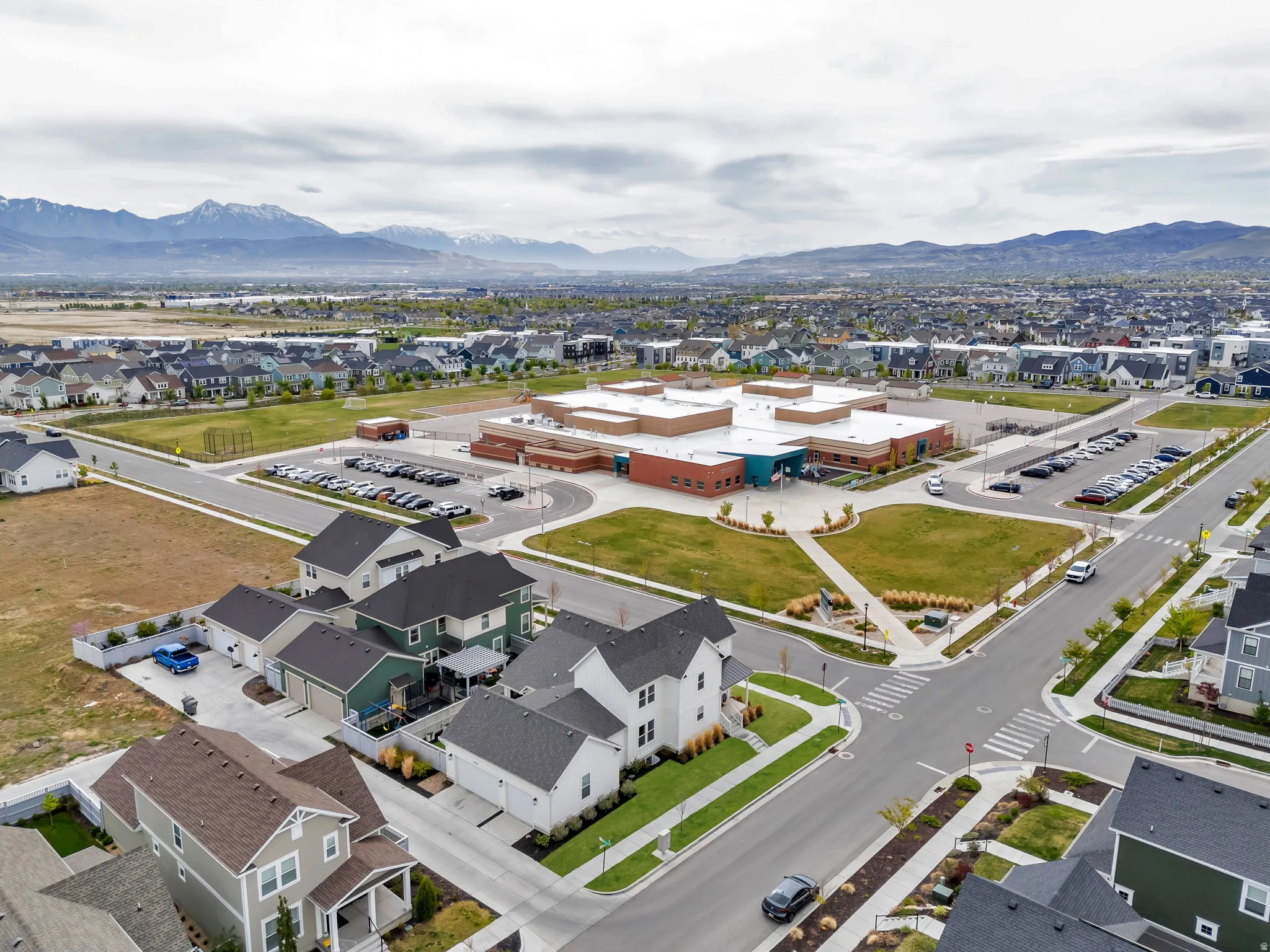 Aerial perspective of suburban area featuring a mountain backdrop