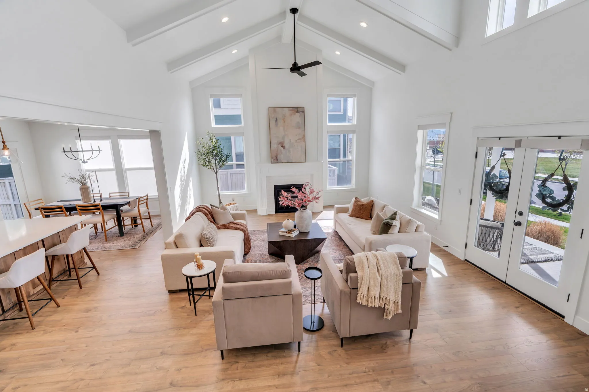 Living area with light wood-type flooring, french doors, a fireplace, and ceiling fan